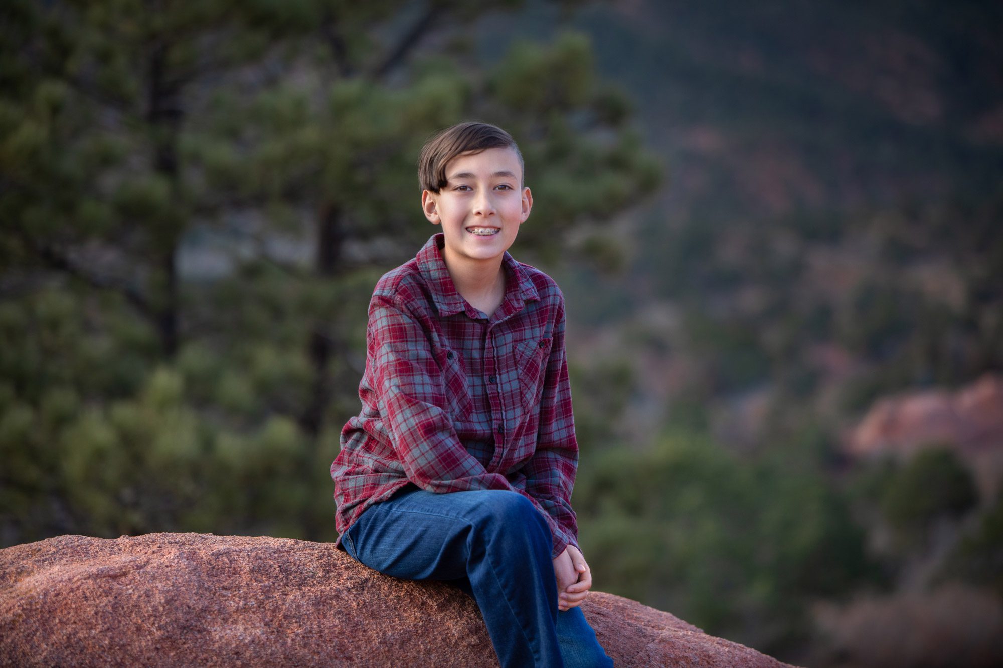 Boy sitting on a rock