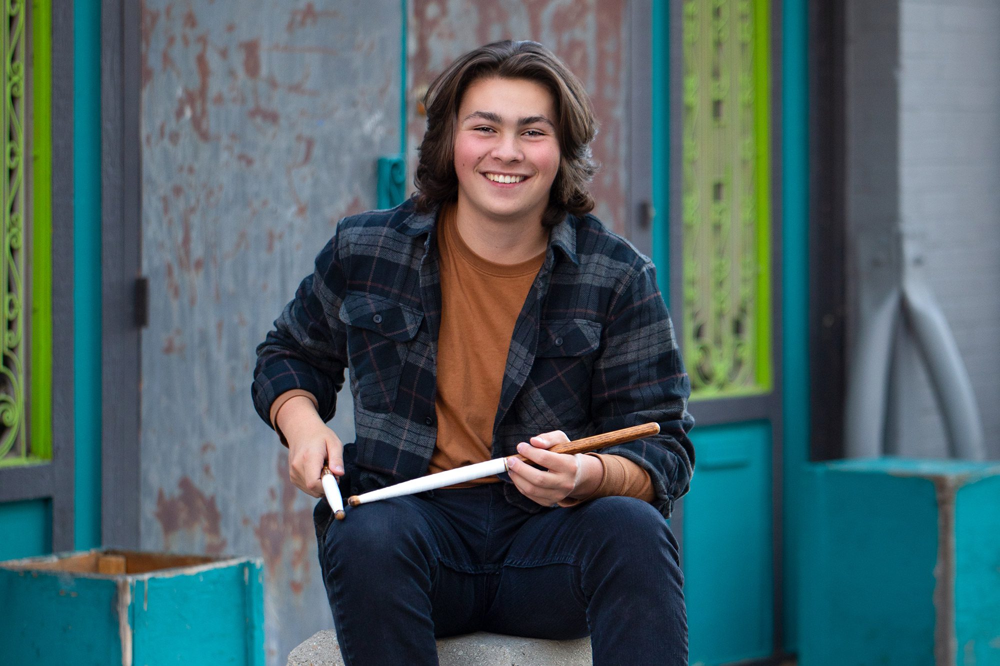 High school senior boy with drumsticks