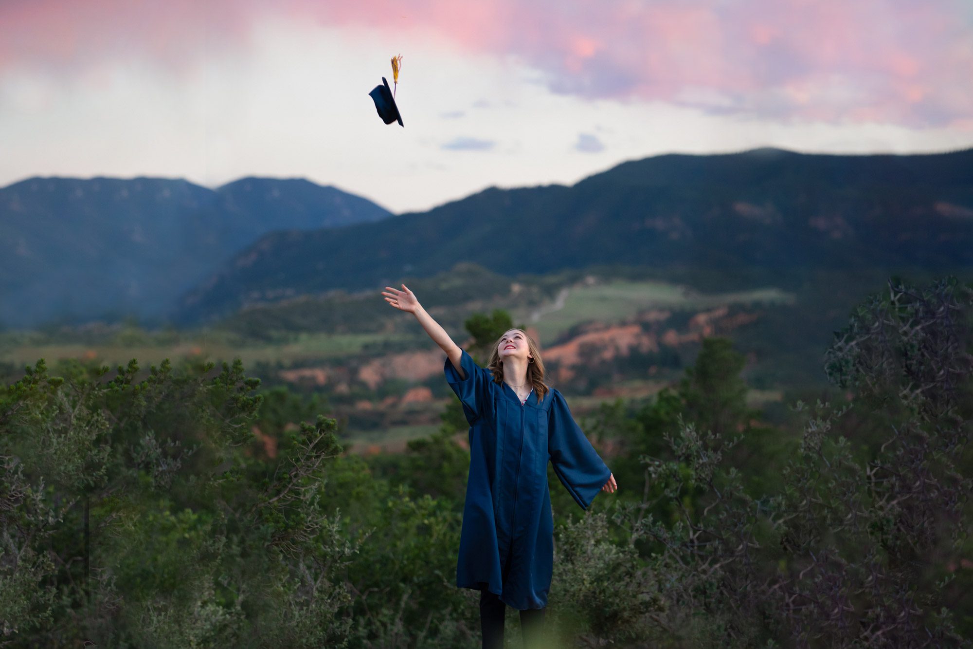 Senior throwing graduation cap in air