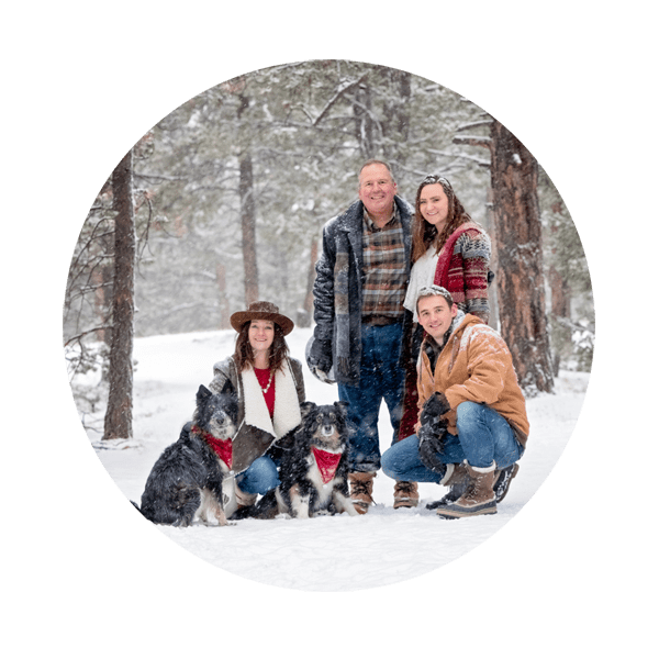 Family with dogs in the snow